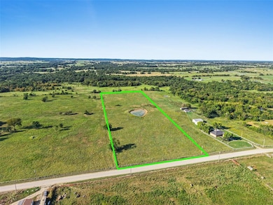 Aerial view of sparsely populated area featuring property boundaries highlighted