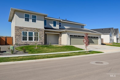 View of front facade with concrete driveway, a garage, and stone siding
