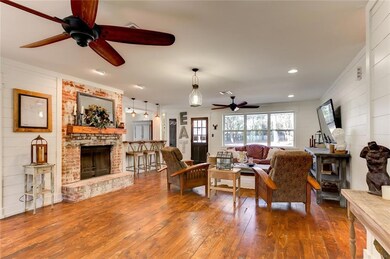 Cozy living room has wood burning fireplace