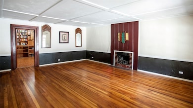 Unfurnished room with hardwood / wood-style floors and a fireplace