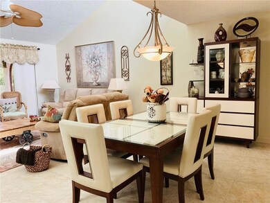 Open living and dining with vaulted ceiling.