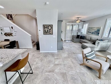 Living room with ceiling fan, light tile patterned