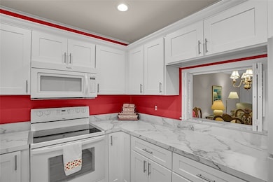 White kitchen - light & bright overlooking the poo