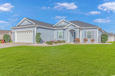 Ranch-style house featuring a front lawn and a gar
