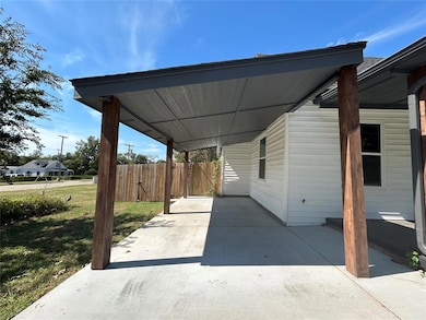 Carport and covered porch providing sheltered access.