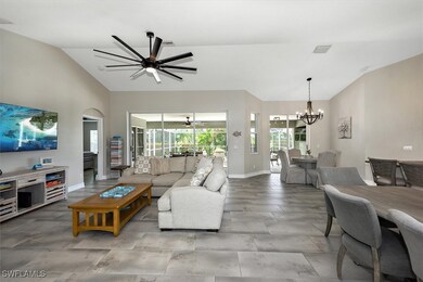 Living room with a chandelier, ceiling fan, and hi