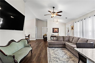 Living room with baseboards, visible vents, a ceil