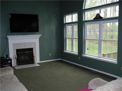 Family Room wall of windows overlooking wooded gre