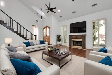 Experience the epitome of comfort and luxury in a living room adorned with lofty ceilings and a crackling gas-log fireplace, perfect for cozy gatherings and relaxation