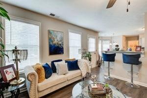 Living area with baseboards, dark wood-type floori