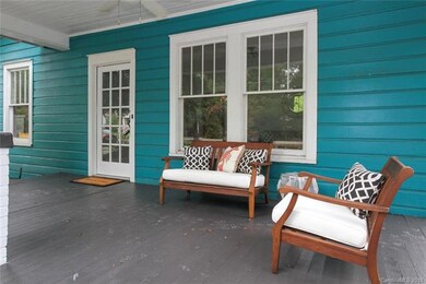 Porch overlooks the tree-lined street and offers a