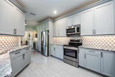 Kitchen featuring custom glass backsplash, ceiling