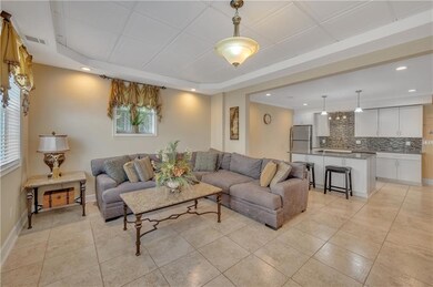 Living room with recessed lighting, light tile pat
