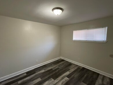 Empty room with dark wood-type flooring