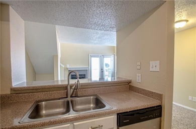 Kitchen featuring stainless steel dishwasher, sink