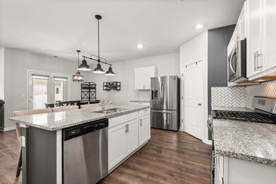Step into the stunning open kitchen, featuring granite countertops, stainless steel appliances, a walk-in pantry, and an expansive center island – the ideal setting for hosting.