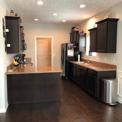 Kitchen with refrigerator remaining and laundry off kitchen