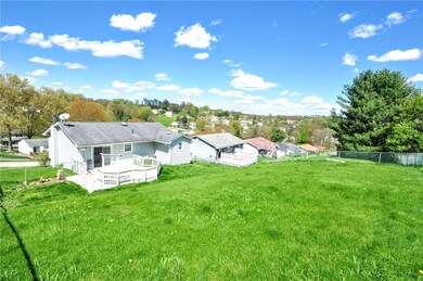 The back of the home showing the fenced in yard