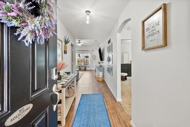 Hallway featuring wood-laminate flooring