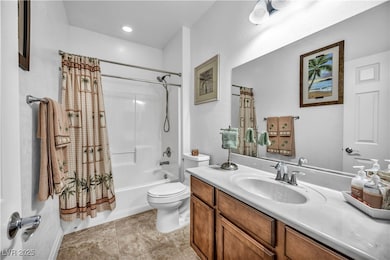 Full bath featuring shower / tub combo, vanity, and light tile patterned flooring