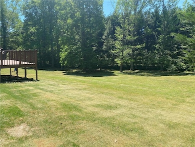 View of green lawn featuring a deck