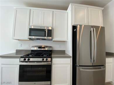 Kitchen with stainless steel appliances and white