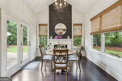 The stunning Casual Dining Room, featuring Vaulted Ceilings, a second Fireplace, and walls of windows that create a bright, airy feel.