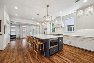 Two pendant lights hang over the island, adding a