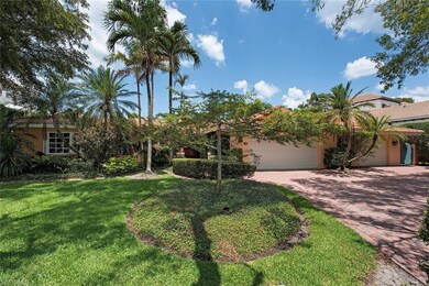 Three car garage and tropical environs.