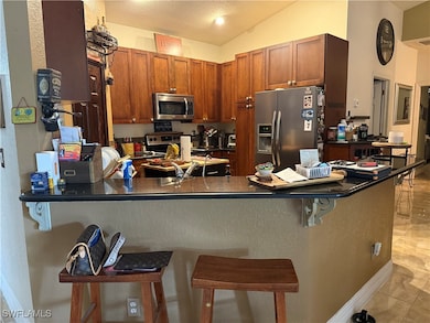 Kitchen with stainless steel appliances, a peninsu