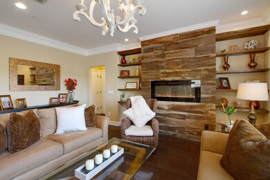 Upgraded lighting, fireplace, shelving and hardwoods in the living room.