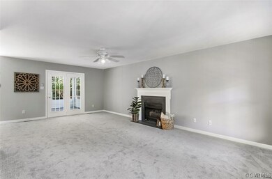 Large family room has fresh paint and new carpet.
