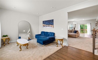 Living room with wood finished floors, baseboards, and recessed lighting
