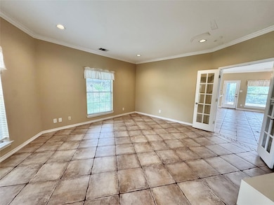 Empty room featuring light tile patterned floors,