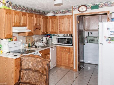 Updated kitchen with ceramic floor, looking into t