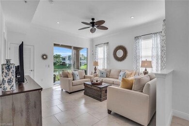 Living room with ceiling fan and light tile floors