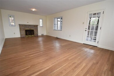 The living room is grand. Newer windows and a ston