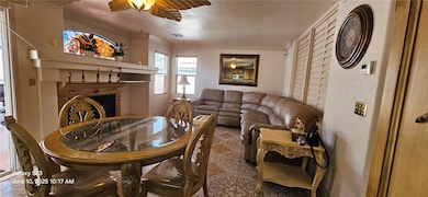 Living room with ceiling fan, ornamental molding,