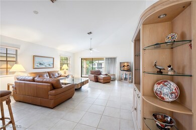 Living room featuring lofted ceiling, light tile p