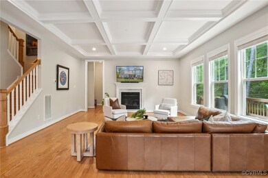 Living room featuring beamed ceiling, light wood-s