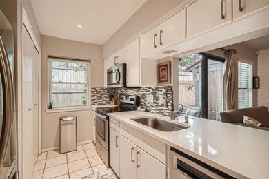 Kitchen featuring stainless steel appliances, whi