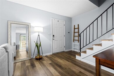 Foyer entrance with dark hardwood / wood-style flo