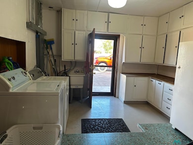 Laundry room with cabinet space and independent washer and dryer