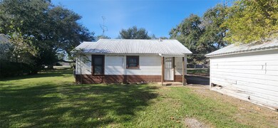 back of home with small porch.