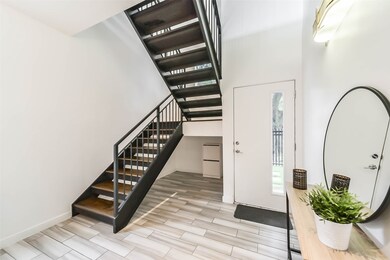 The foyer features additional space under the stai