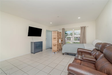 Bedroom featuring light tile patterned floors and recessed lighting