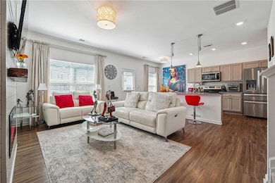 Living area featuring recessed lighting, dark wood