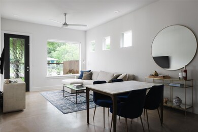 Living area featuring ceiling fan and baseboards