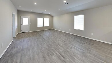 Spare room featuring wood-type flooring and a heal