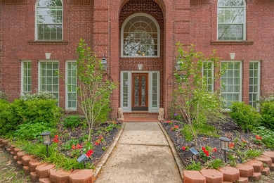The freshly landscaped front yard features vibrant